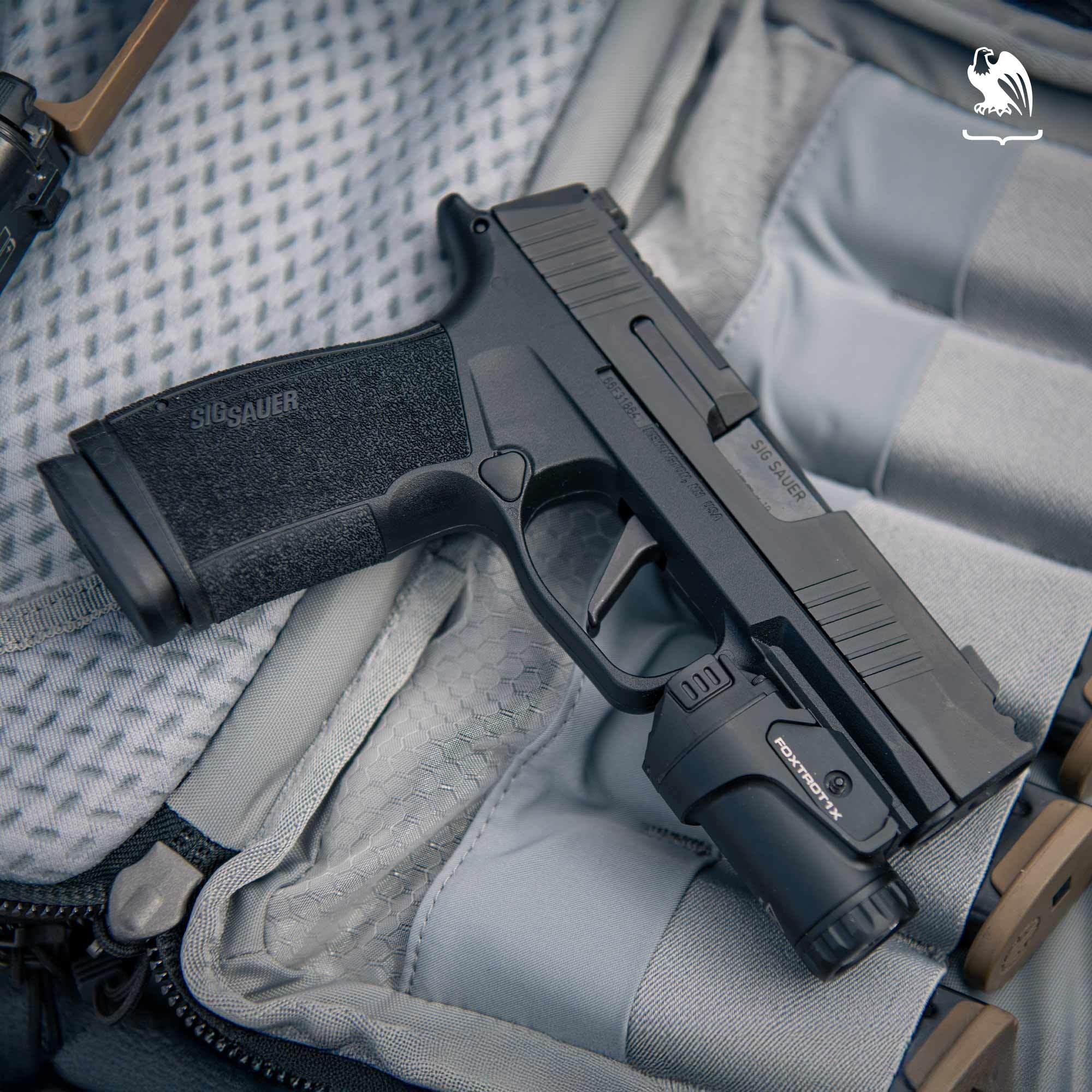 Sig Sauer P365 X-Macro compact 9mm concealed carry pistol with integrated compensator on white background